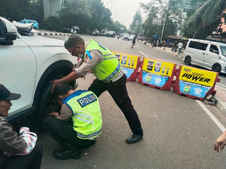 Tindakan Mulia: Anggota Unit Lantas Cengkareng Bantu Pengendara Mobil yang Alami Ban Kempes